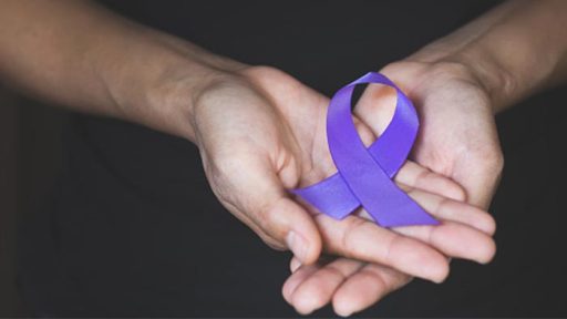 hands with purple ribbon