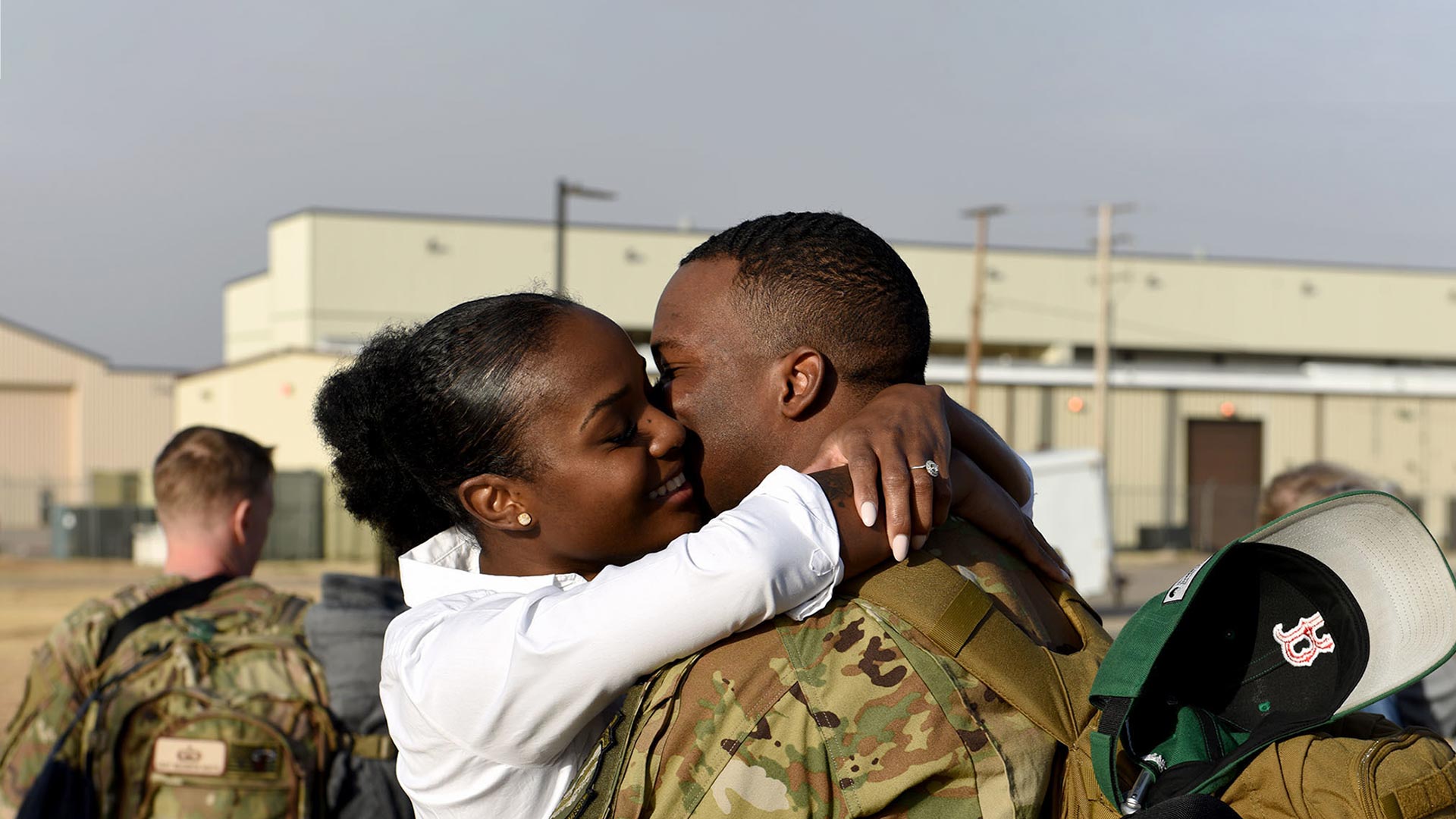 service member and spouse embracing