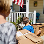 mother and son move boxes