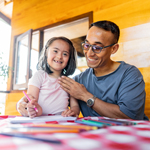 Father helping daughter with homework