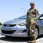 soldier stands by car