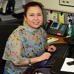 woman smiles at desk
