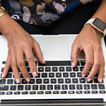 Woman types on keyboard