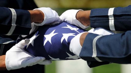 hands holding folded flag
