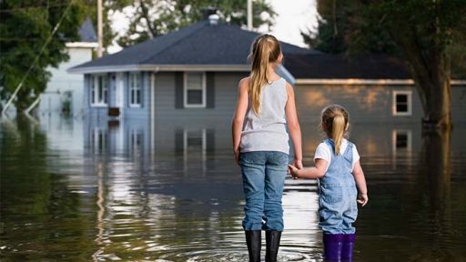 kids near flooded home