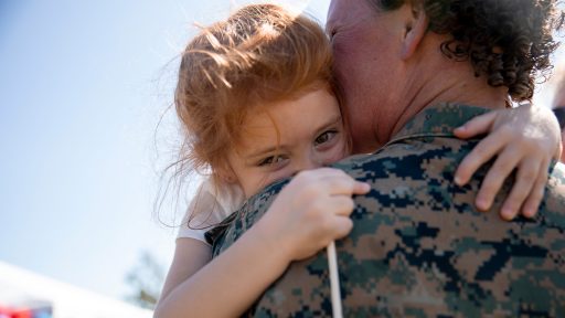 Marine mom holds her daughter