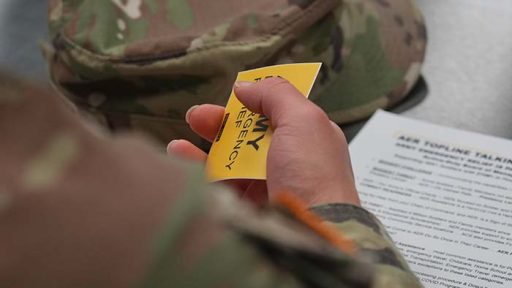 service member holding emergency relief info