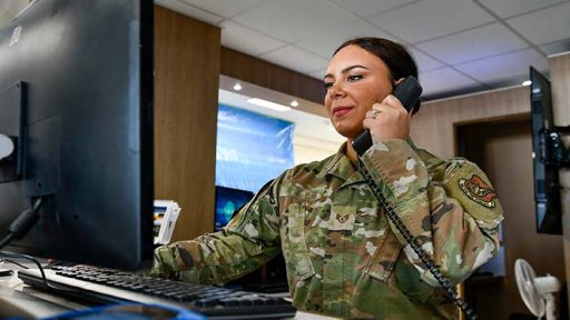 service member on phone at desk