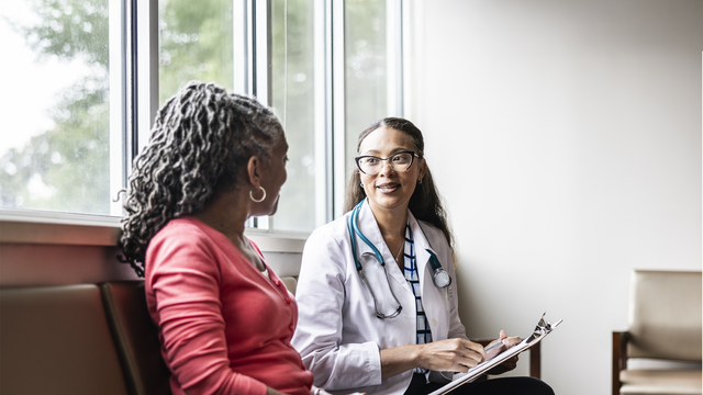 female doctor talking with senior woman