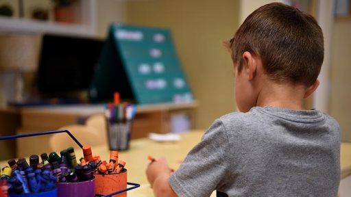 child coloring at the table