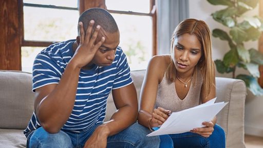 couple concerned looking at papers