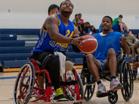 Disabled players in wheelchairs playing basketball
