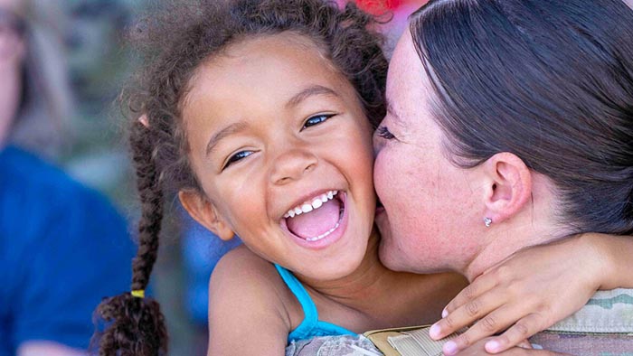 service member and child smiling