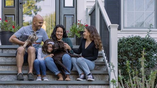 family on house steps
