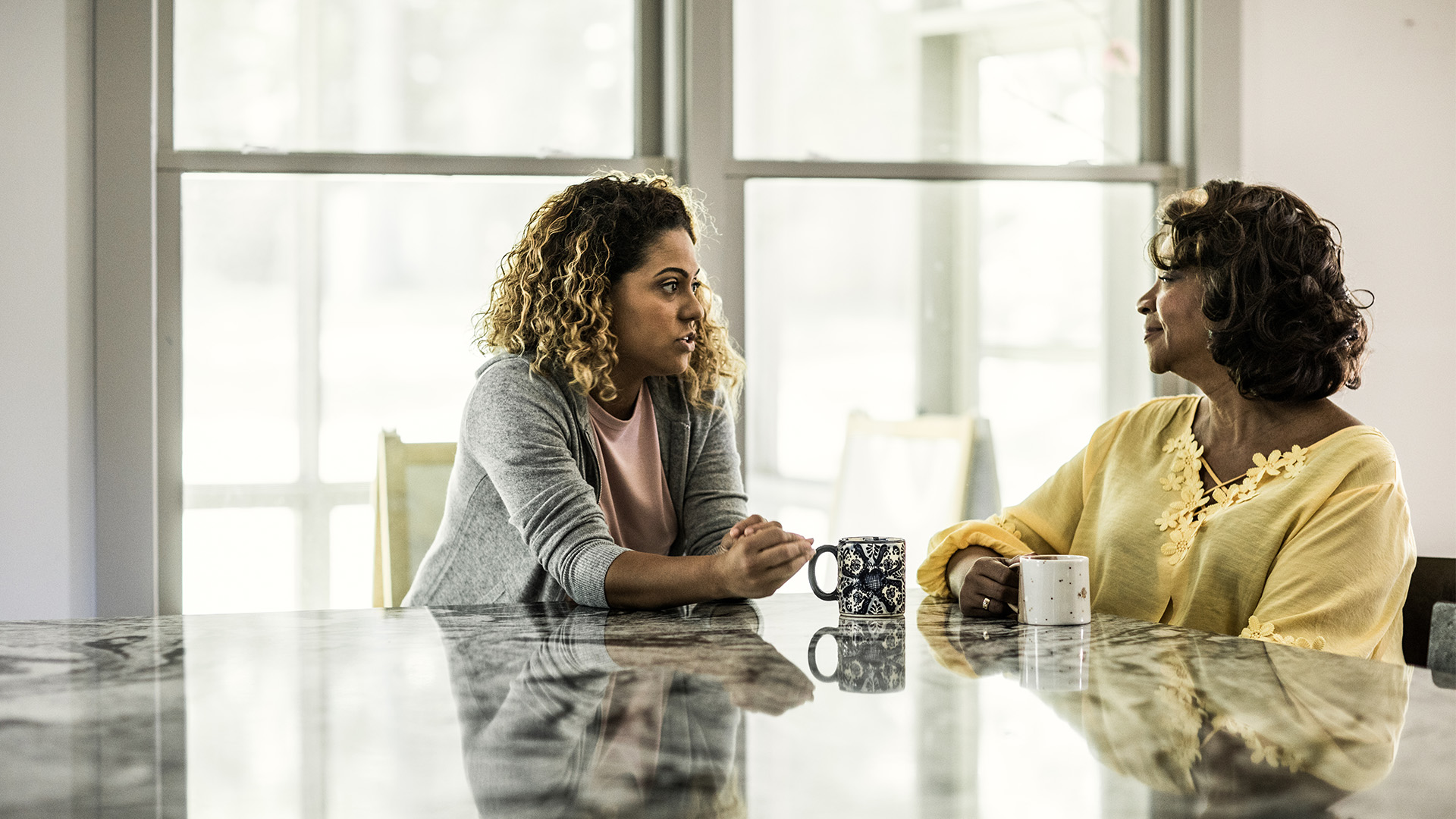 two women talking at table
