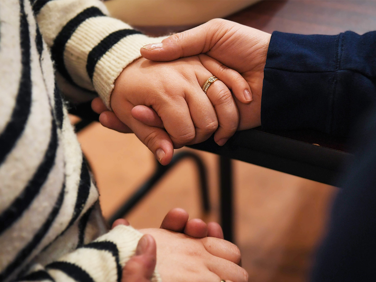A couple holds hands