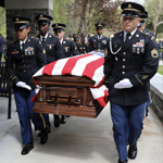 Service members carry casket during funeral service