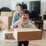 child moving boxes