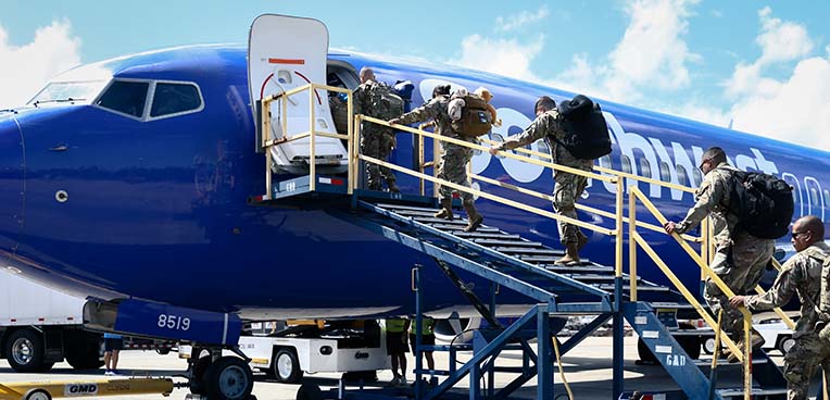 service members boarding airplane