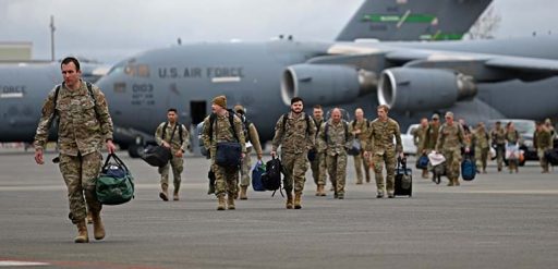 service members leaving airplane