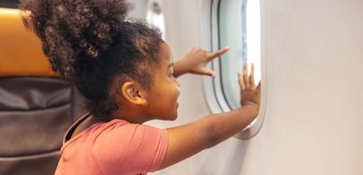 Girl looking out airplane window