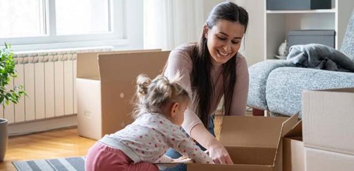 Mother and child packing boxes