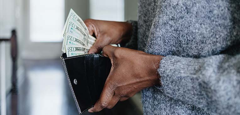 Person taking money out of wallet