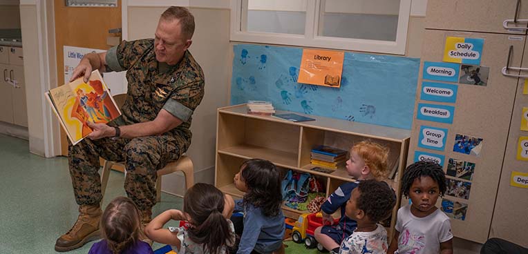Service member reading to kids