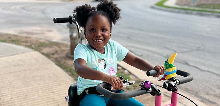 child using special needs bike