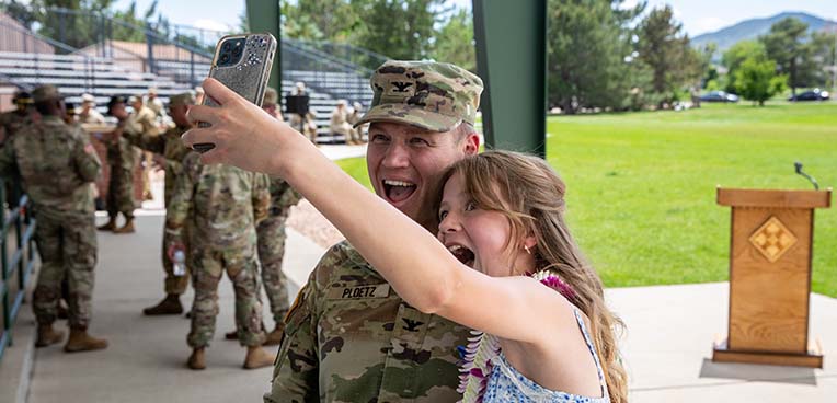 service member and teen taking selfie