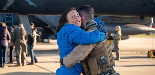 service member hugging spouse