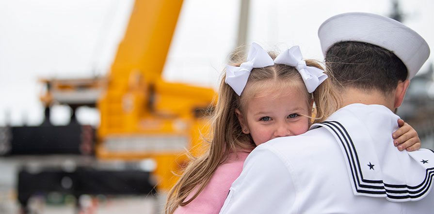 service member hugs daughter upon return