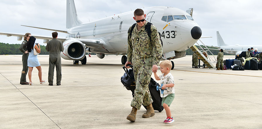 Service member walking with child