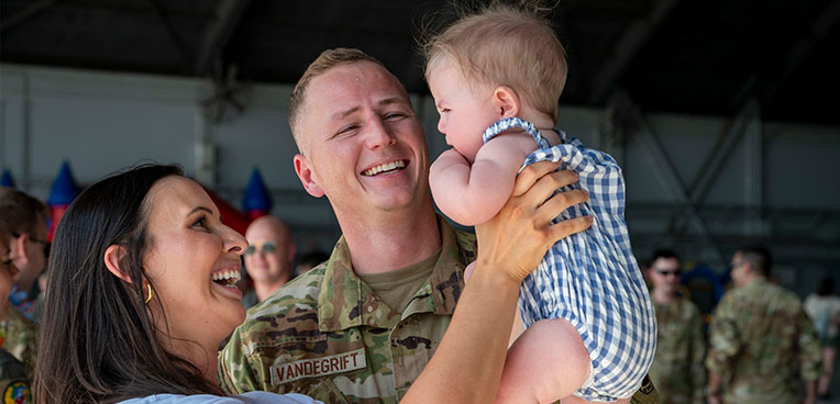 service member with wife and baby