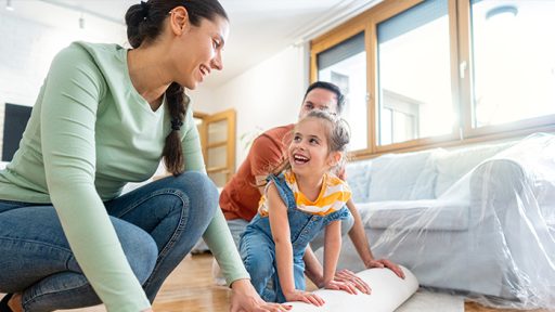 Rolling up carpet with family