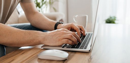 male hands on laptop keyboard