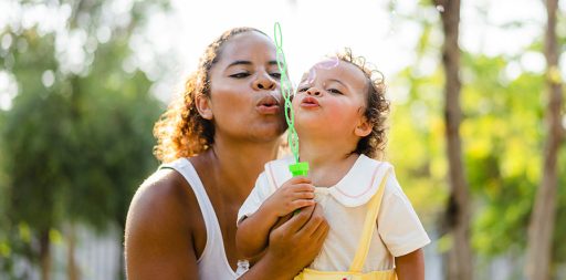 Mother and child blowing bubbles