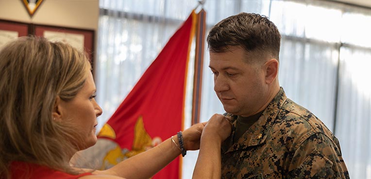 person pinning service member