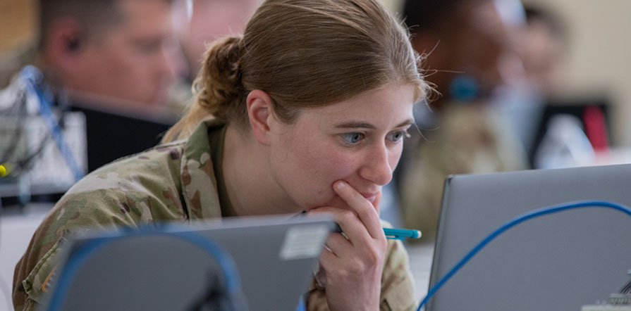 service member looking at computer
