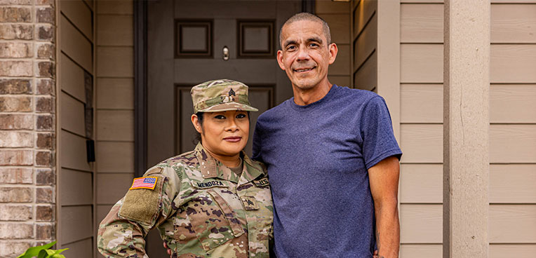 Service member standing with spouse