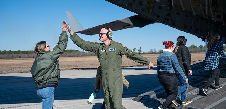 service members high fiving