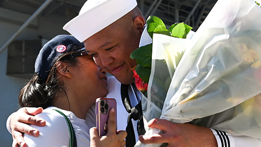 Family member hugging service member
