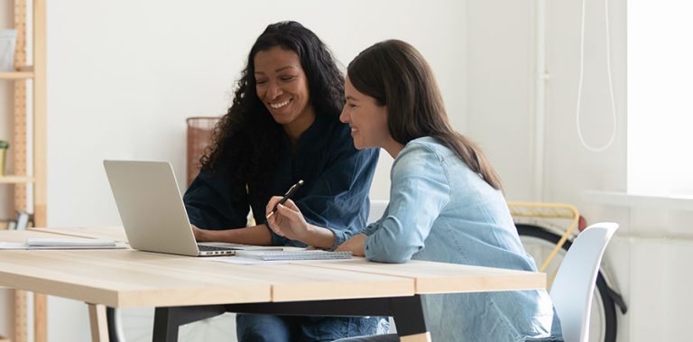 two women working on computer