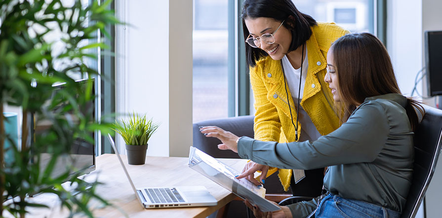 woman reviewing files with employee