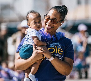 Service member holding baby