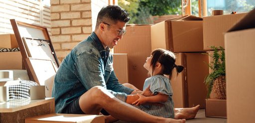 father and child with moving boxes