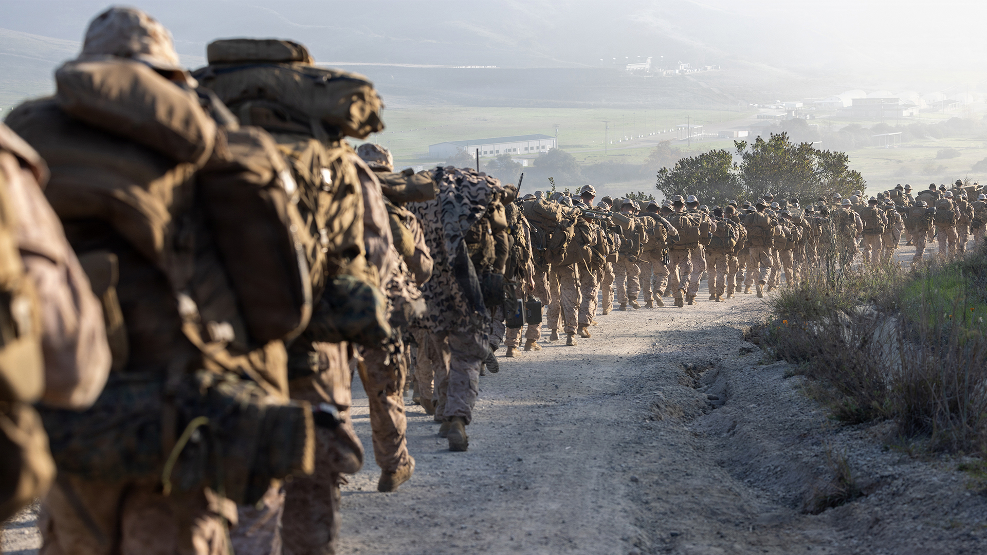 Service members hike during combat readiness