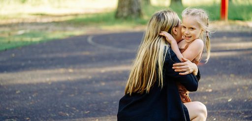 mother hugging young daughter