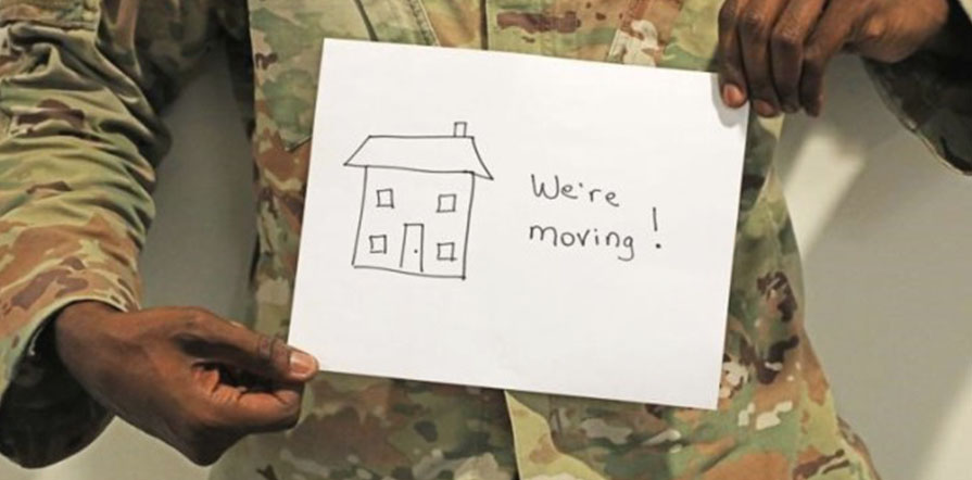 service member holding moving sign