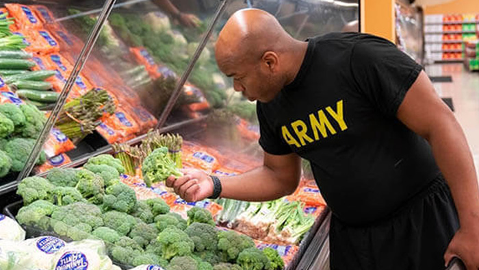 Service Member picking out food.